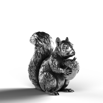Silver statue of a squirrel holding an acorn, made of 999 fine silver.